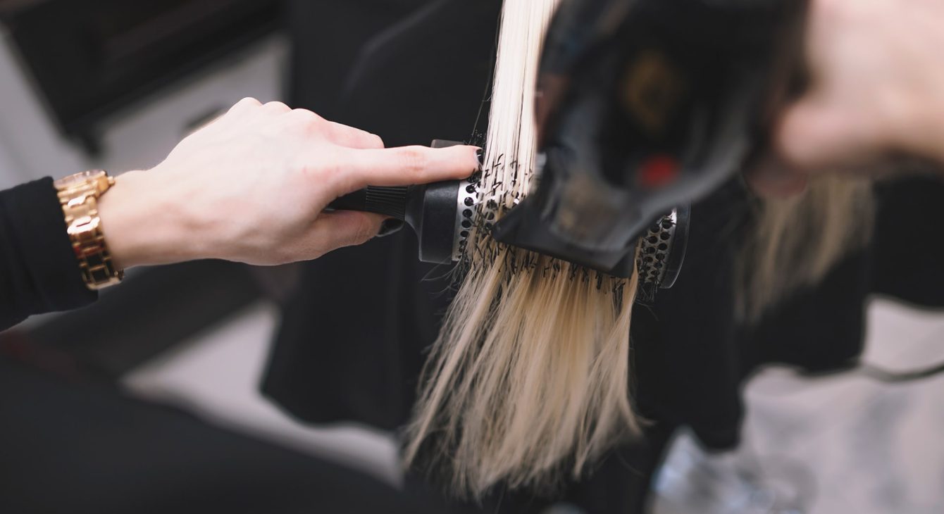 crop-stylist-setting-hair-with-brush