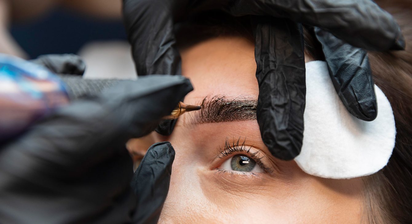 young-woman-getting-beauty-treatment-her-eyebrows