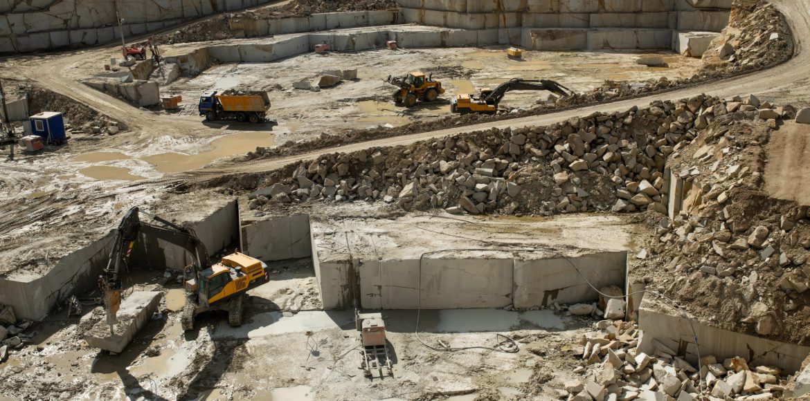 Group of large caterpillar machines working on building area